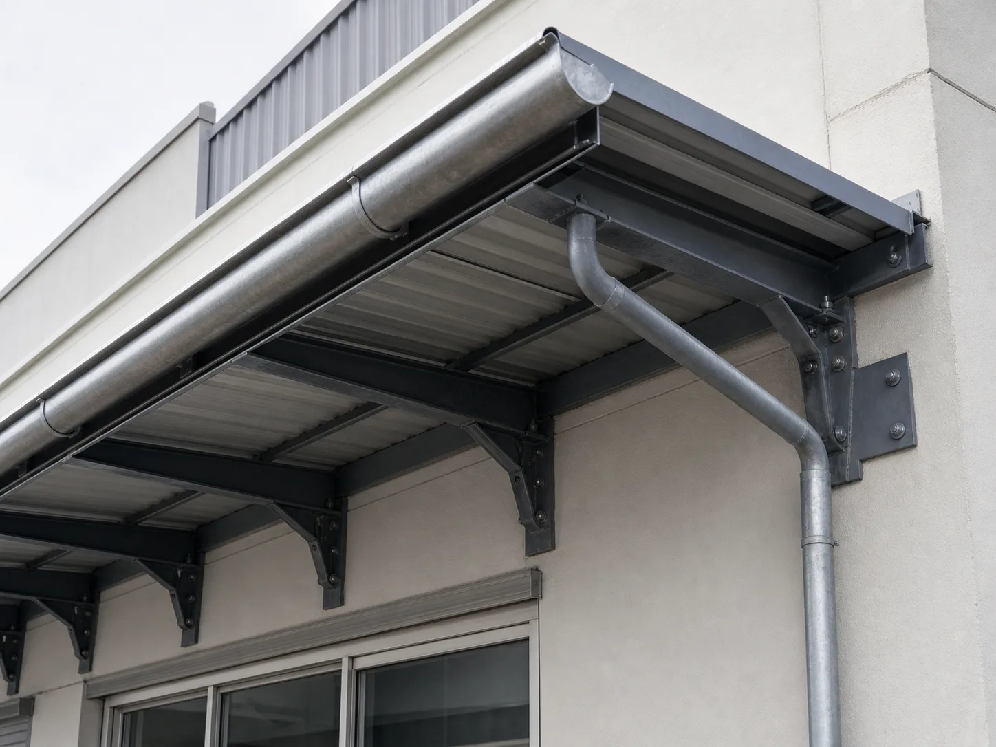 A steel-framed awning over a shopfront, seen from below and to one side so the frame reads
